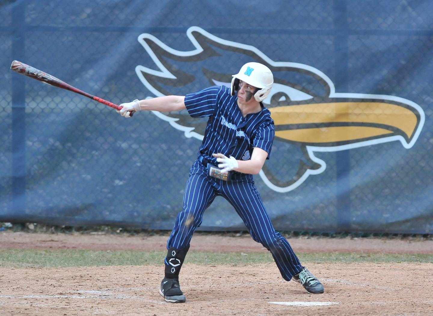 Nazareth's Nick Drtina hits an RBI sacrifice fly during a game against Benet Academy on Apr. 12, 2022 at Nazareth Academy in LaGrange Park.