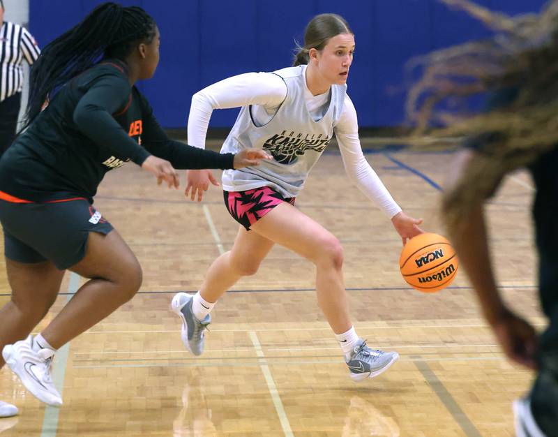 Kaneland’s Grace Brunscheen goes around a DeKalb defender Thursday, June 12, 2025, in the Geneva High School Varsity Summer League.
