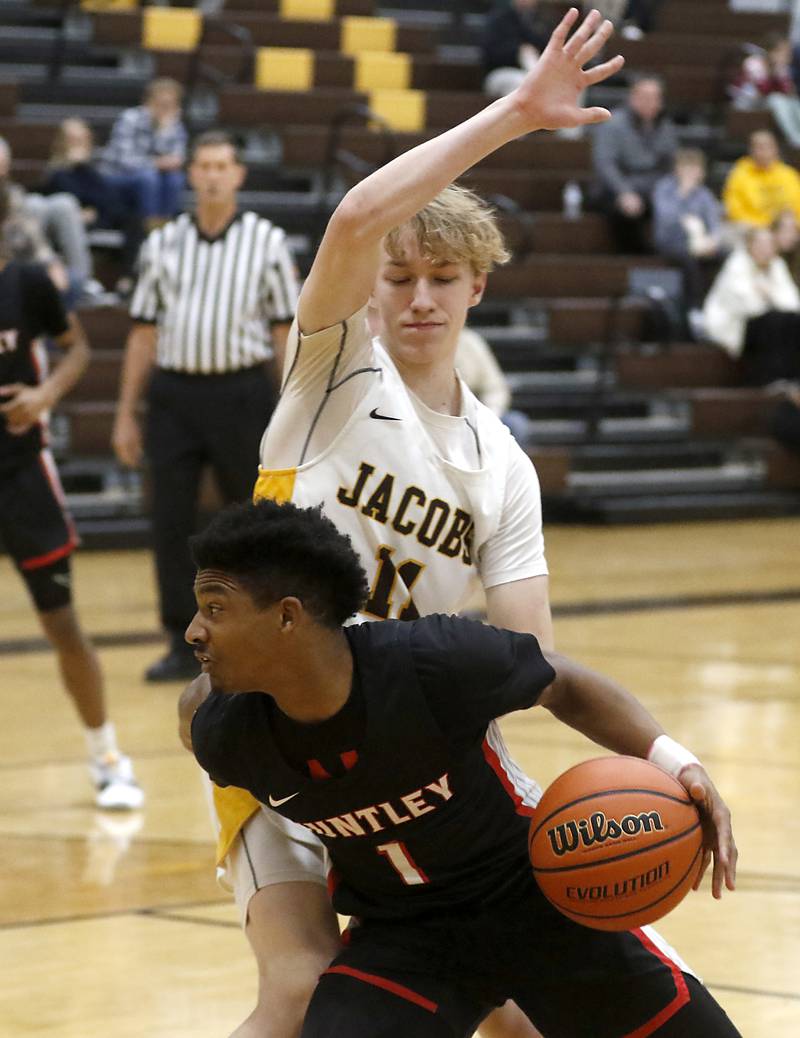 Huntley's Bryce Walker drives to the basket against Jacobs' Max Fessler during a Fox Valley Conference boys basketball game on Wednesday, Dec. 6, 2023, at Jacobs High School in Algonquin.