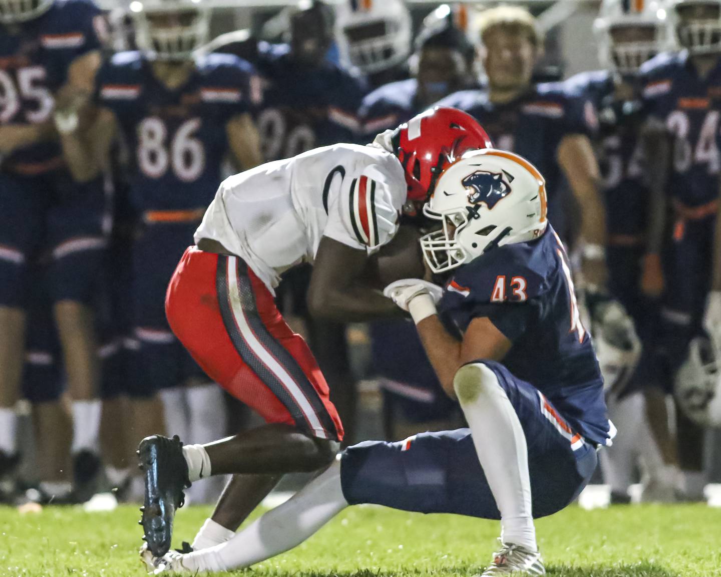 Oswego's Ethan Pilip (43) sacks Bolingbrook's Tyson Ward (7) during football game between Bolingbrook at Oswego Friday, Sept 12, 2025  in Oswego.
