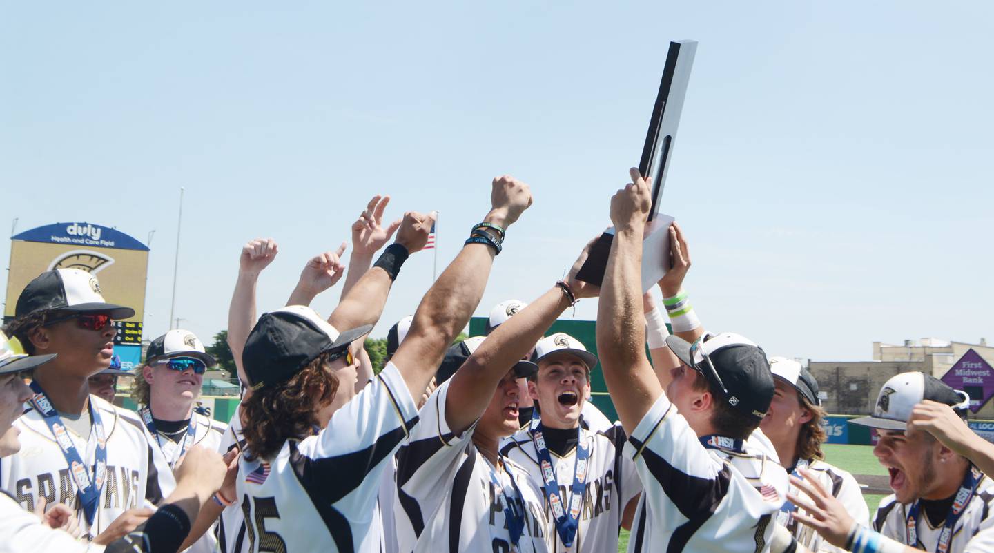 Joe Lewnard/jlewnard@dailyherald.com
Sycamore players celebrate with their trophy after defeating Effingham 2-1 in nine innings during the Class 3A  third-place state baseball game in Joliet Saturday.