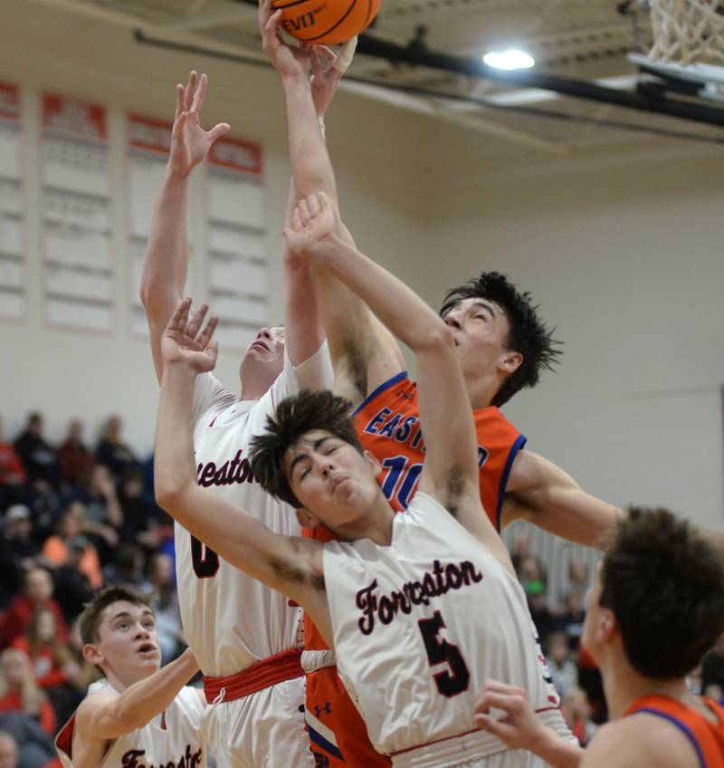 Eastland's Zyacn Haverlund (10) and Forreston's Brendan Greenfield ((00) and Joey Kobler (5) battle for a rebound on Saturday, Jan. 4, 2025 at Forreston High School.