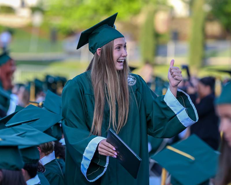 Students celebrate receiving their diplomas during the Glenbard West High School graduation ceremony. May 19, 2022