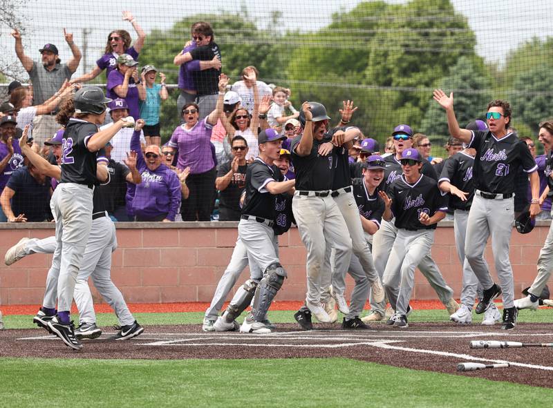 Downers Grove North celebrates Jimmy Janicki's walk-off homerun in the bottom of the 7th during the IHSA Class 4A baseball regional final between Downers Grove North and Hinsdale Central at Bolingbrook High School on Saturday, May 27, 2023.