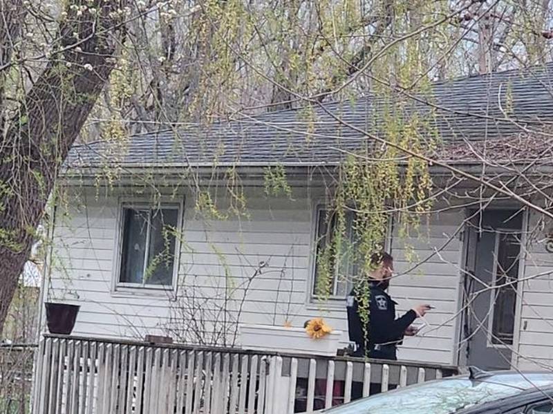 An officer stands in front of a home near Johnsburg in a neighborhood where McHenry County Sheriff's deputies shot and killed a dog after a dogfight that authorities said injured several people. At least one deputy was also injured trying to corral the dogs after two got loose.