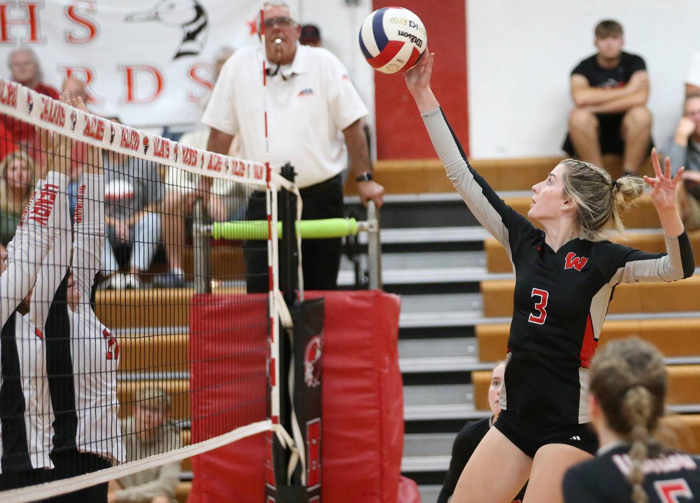 Woodland's Malayna Pitte sends the ball to the Henry-Senachwine side of the net in a match this past season at Henry-Senachwine High School.