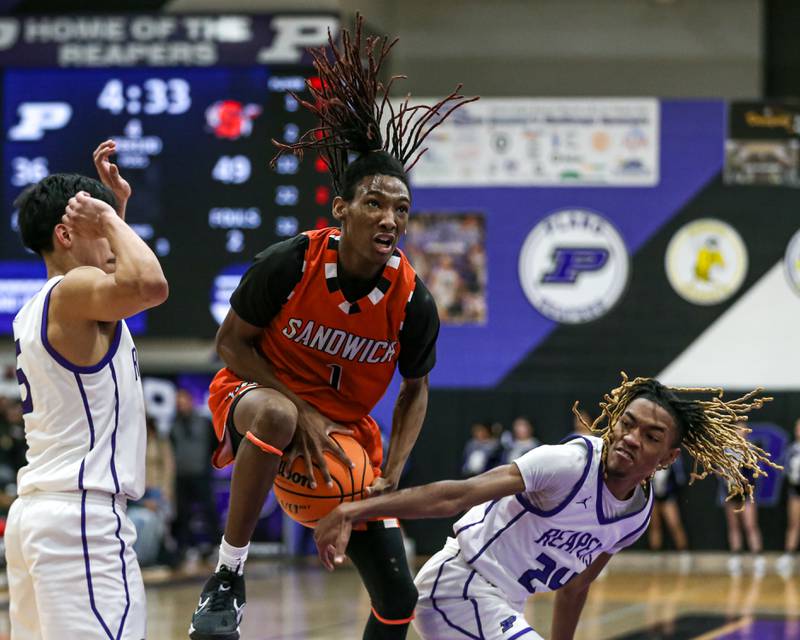 Sandwich's Simeion Harris (1) is fouled on a layup attempt during their basketball game between Sandwich at Plano. Jan 27, 2025 in Plano.