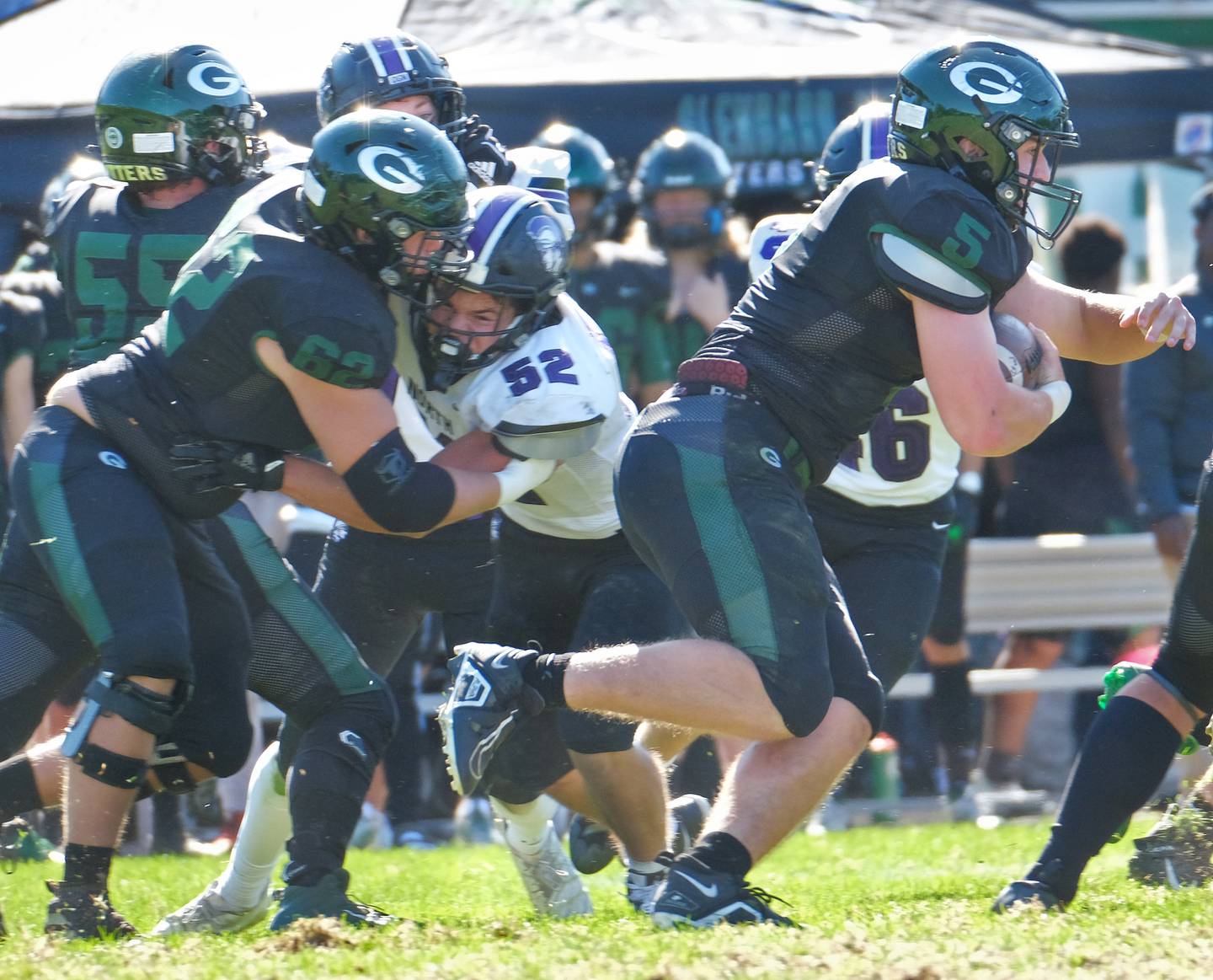 Glenbard West's Jack Oberhofer (5) powers the ball forward for a first down against Downers Grove North during a game on Oct. 8, 2022 at Glenbard West High School in Glen Ellyn.