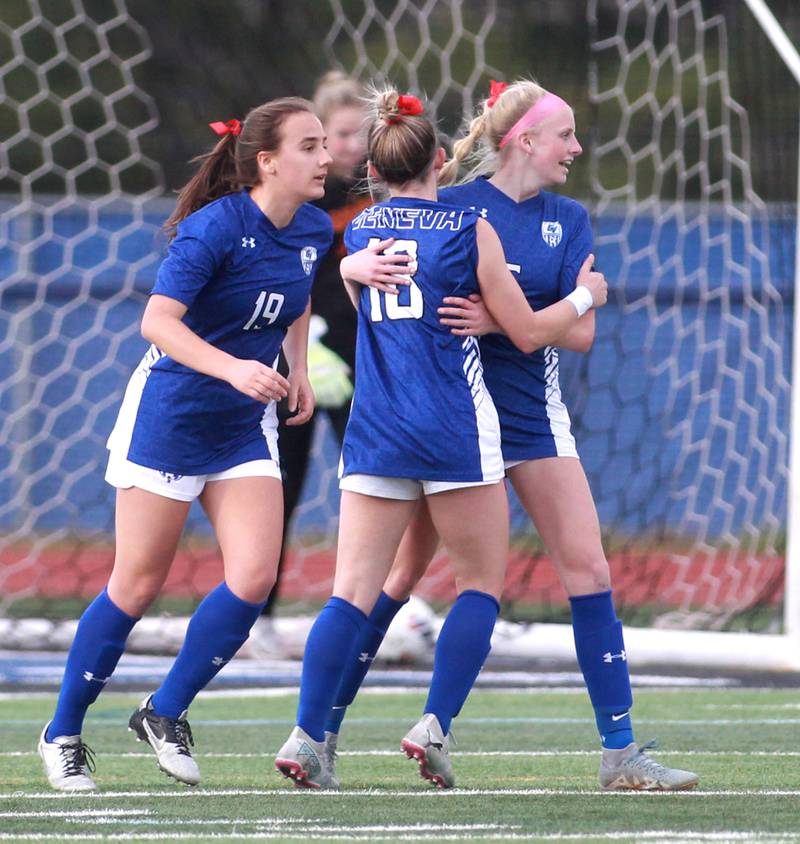 Geneva players Evyn Schokora (left) and Riley Pryor (center) celebrate a goal by Audrey Stredde (far right) during a Tri-Cities Night game against Batavia at St. Charles North on Tuesday, April 23, 2024.