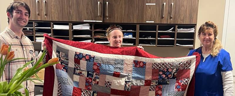 Retired U.S. Air Force Lt. Col. Julia Ritz (right) receives her Quilt of Valor honoring her military service.