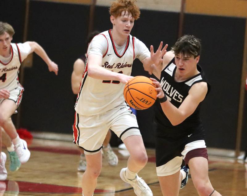 Huntley’s Logan Darragh, left, battles Prairie Ridge’s Eli Loeding in varsity boys basketball on Tuesday, Feb. 18, 2025, at  Huntley High School in Huntley.
