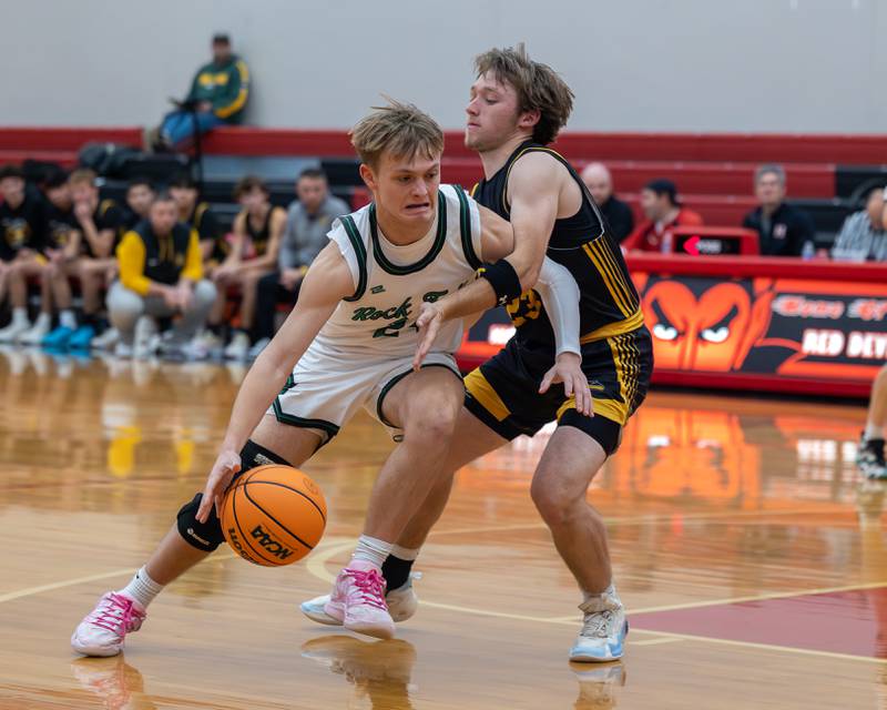 Owen Mandrell (24) of Rock Falls drives ball in lane as Branden Bickerman (23) of Putnam County guards at hip during the Colmone Classic on Monday, December 8, 2025 at Hall High School in Spring Valley.