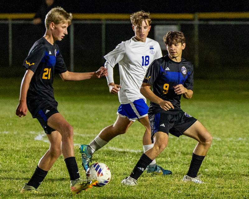 Carson Harper (21) of Somonauk/Leland/Newark dribbles ball as Colten Sargent (18) of Hinckley-Big Rock and (9) of Somonauk/Leland/Newark watch on during the Little Ten Conference Championship match on Thursday, Oct. 9, 2025 at Hinckley-Big Rock School in Hinckley.