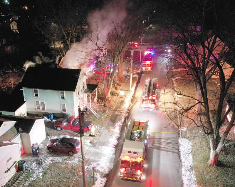 Smoke billows from a home in the 300 block of South Chestnut Street as firefighters work the scene on Friday, Dec. 19, 2025 in Princeton. Firefighters from Malden, Bureau, Walnut, Princeton, Spring Valley, Ladd and Wyanet all responded  to the scene. Flames could be seen when the fire departments arrived coming from the second story. The fire happened shortly after 5:15p.m.