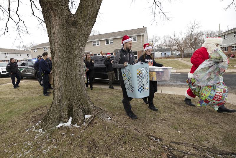 Rock Falls fire and police personnel make their first stop of the day Monday, Dec. 23, 2024, for Operation Santa.