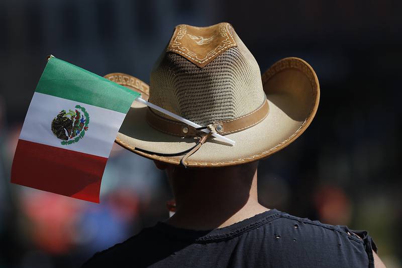 A man where a Mexican flag on this has  on Sunday, Sept. 14, 2025, during the annual Hispanic Connections Mexican Independence Day Celebration in the Historic Woodstock Square. The celebration featured music, food and culture.