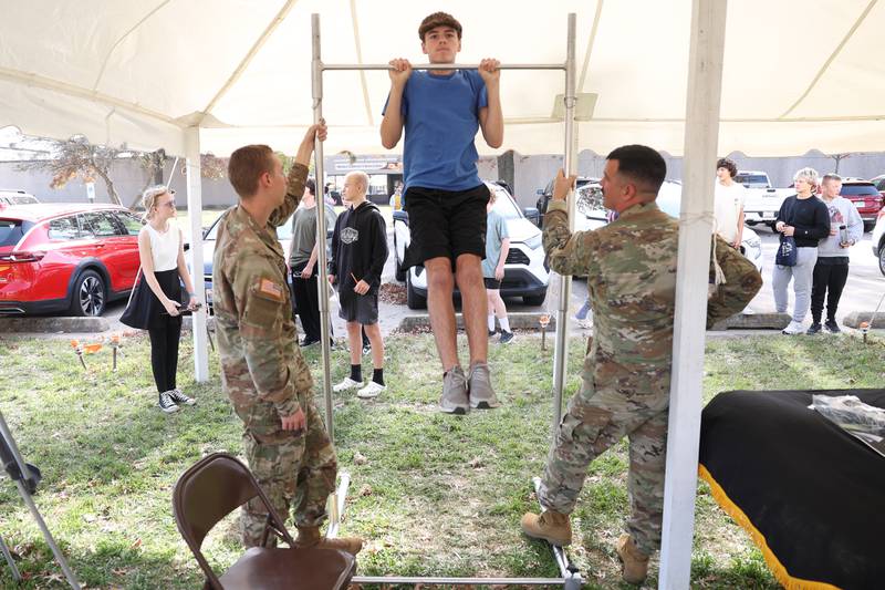 A student does pull-up at the U.S. Army tent at the Grundy Area Vocational Center 8th grade Career Fair at Morris High School on Tuesday, Oct. 29, 2024 in Morris
