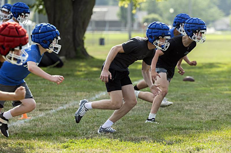 Newman players run through drills during first day of football practice Monday, August 7, 2023.