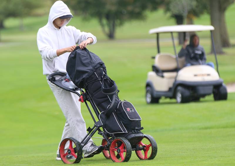 Erie-Prophetstown's Caden VanHorn pushes his cart through the rain during the Three Rivers Athletic Conference boys varsity tournament on Tuesday, Sept. 19, 2023 at Mendota Golf Club.