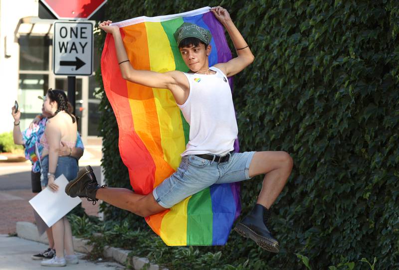 Sam De La Cruz, 15, from DeKalb, has some fun as he and his friends wait for the parade to start Thursday, June 23, 2022, during an event to celebrate Pride month in DeKalb. The function included a short parade through downtown and a showing of the movie “Tangerine,” with a panel discussion afterwards at the Egyptian Theatre.