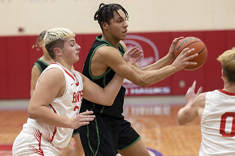 Rock Falls’ Devin Tanton-DeJesus makes a pass while being defended by Oregon’s Kade Girton Tuesday, Dec. 12, 2023 in Oregon.