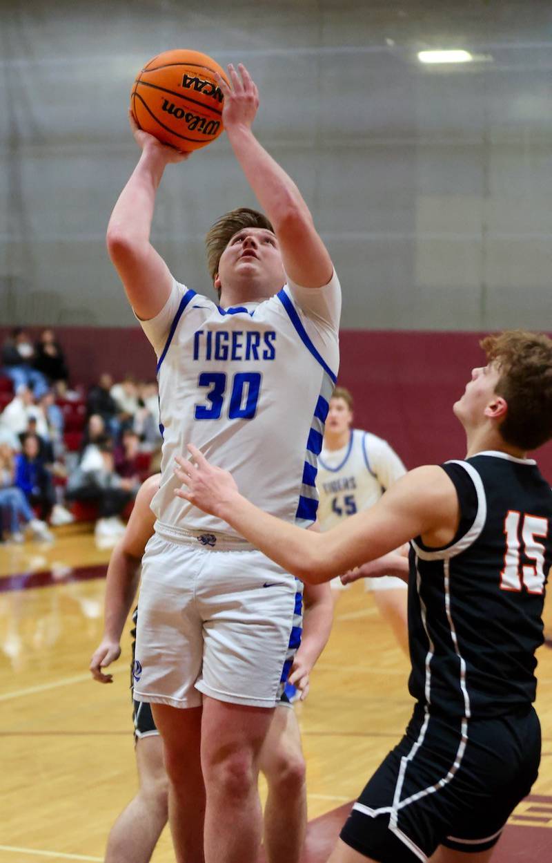 Princeton's Jordan Reinhardt shoots over  Byron's Ben Hively in Wednesday's sectional semifinals at Marengo. Princeton won 46-42 to advance to Friday's championship against Rock Falls.