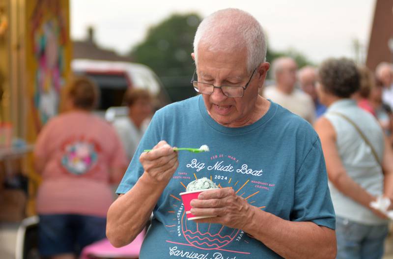 Jerry Stauffer of Mt. Morris digs into his dish of ice cream from the Just 4 Fun ice cream truck during the Captain Rat and the Blind Rivets concert at the Mt. Morris Jamboree concert on Friday, Aug. 15, 2025.
