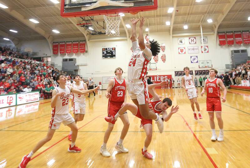 L-P's Marion Persich lets go of a shot underneath the hoop as Ottawa's Klyer Araujo fouls him on Friday, Feb. 7, 2025 in Sellett Gymnasium at L-P High School.
