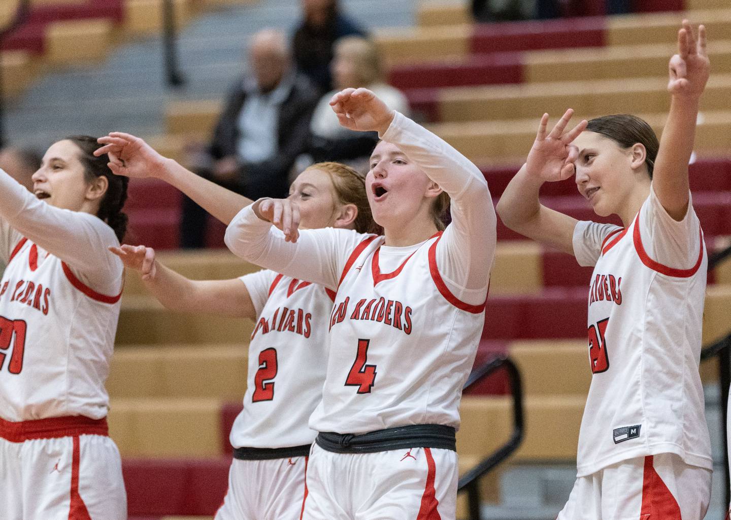 The Huntley High School girls basketball team celebrates a three-point field goal made by a teammate during a home game against Cary-Grove High School on Tuesday, Dec. 3, 2024.