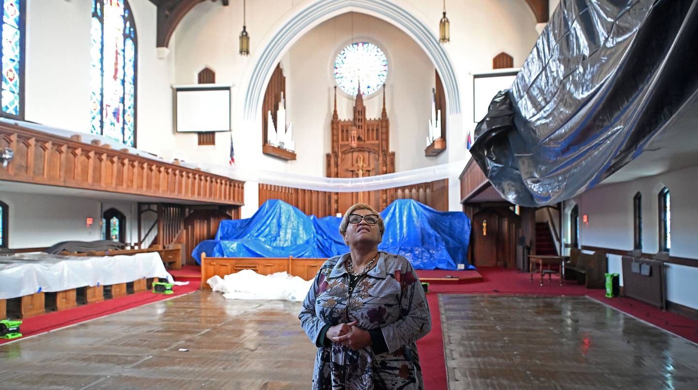 Rev. Felicia LaBoy looks up at some of the damage caused by a storm that blew off a large section of the roof of the First United Methodist Church in Elgin Friday night. Aside from some water leaking, the sanctuary was largely spared.