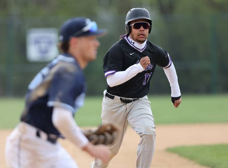 Downers Grove North's Noah Battle (17) breaks for third during the varsity baseball game between Downers Grove South and Downers Grove North in Downers Grove on Saturday, April 29, 2023.