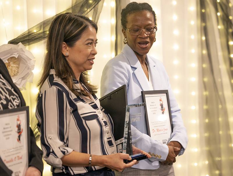 Drs. Nancy Tran (left) and Marcia Jones react to winning the Crete Dillon Bowman Award Thursday, April 16, 2026, at the YWCA’s Women of Achievement Luncheon.