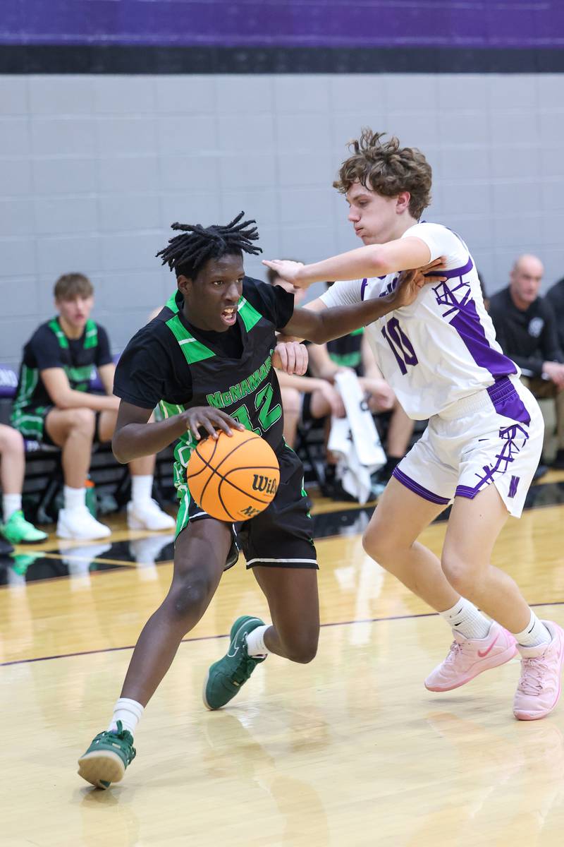 Bishop McNamara's Corey Hathaway drives to the lane against Manteno's Jack Gotkowski during the Fightin' Irish's 61-24 victory over Manteno on Tuesday, Jan. 13, 2026.
