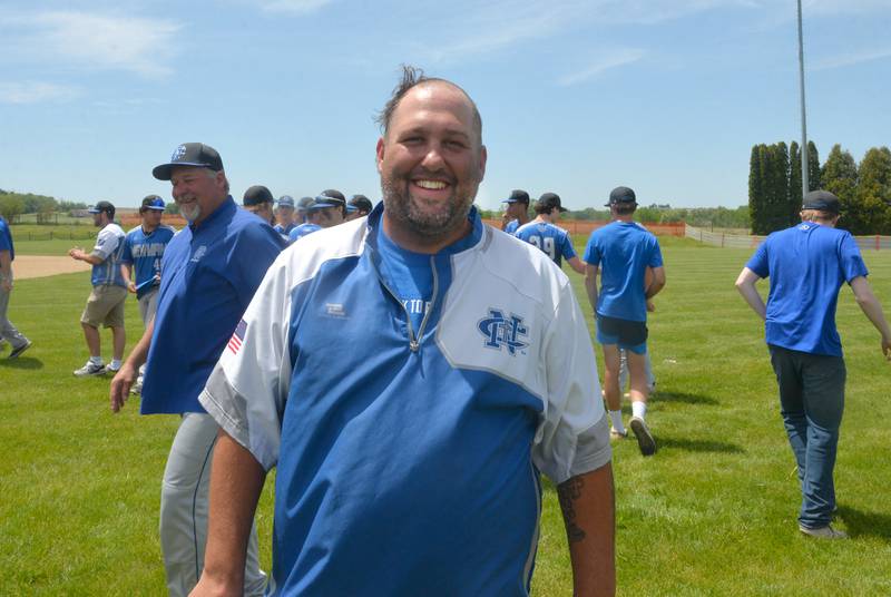 Newman coach John Kutz smiles as he shows his half-shaven head after the Comets beat Dakota 10-7 at the 1A Pearl City Sectional on Saturday, May 27. The shaving of his head has been an after-game tradition for the Comets after each of their wins since the regional.