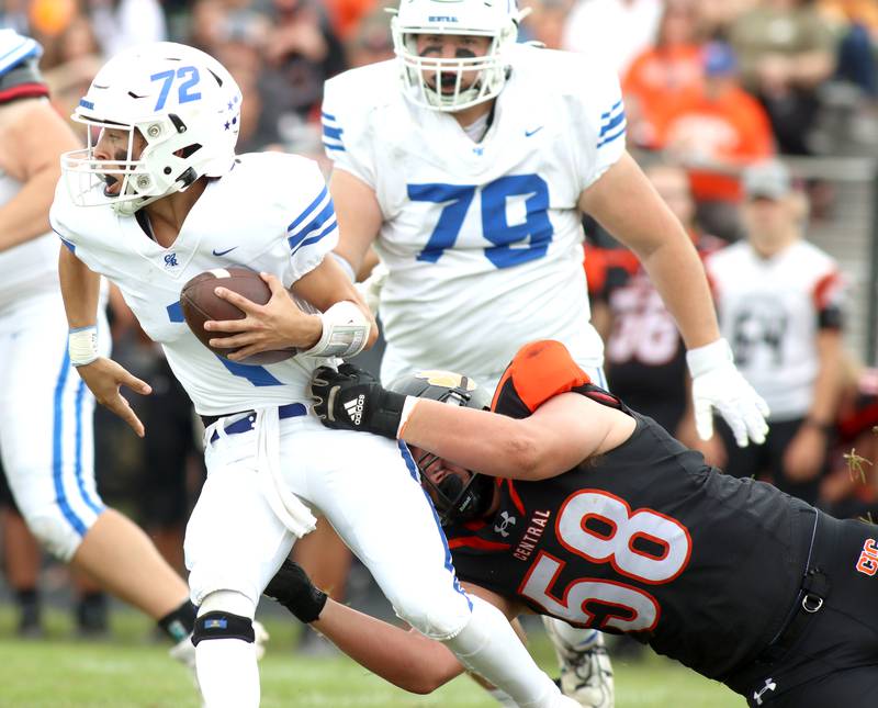 Crystal Lake Central’s Nicholas Kozlowski, right, snags  Burlington Central quarterback Ryder Bergemann in varsity football at Crystal Lake Saturday.
