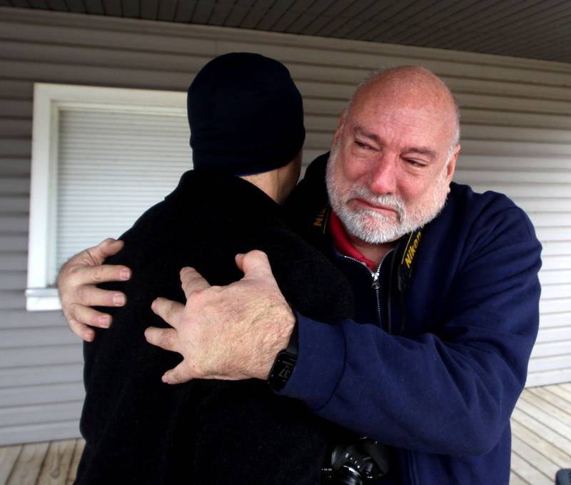 Former Wonder Lake Fire Protection District first responder Pete Diedrich on Saturday embraces Brian Nicosia, left, near the scene of a 1982 midair military jet explosion that happened over the small, rural area northeast of Woodstock. Nicosia’s father and 26 others were killed as the plane exploded midair at 9:11 p.m. Diedrich was among the first on the scene, and had the grim task of pulling the deceased crew from the wreckage. Nicosia’s father, Co-pilot Capt. Robert J. Nicosia of Algonquin, was among the crew. In all the years since the explosion, Saturday was the first occasion Diedrich had to visit with any of the crew’s loved ones.