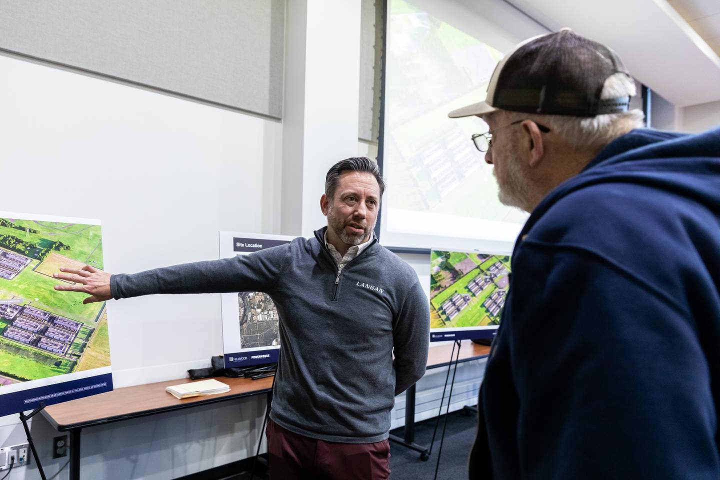 A representative from Langan chats with Elwood resident Everett Hauert about the proposed Joliet Technology Center during a community open house event at Joliet Community College on Feb. 12, 2026.