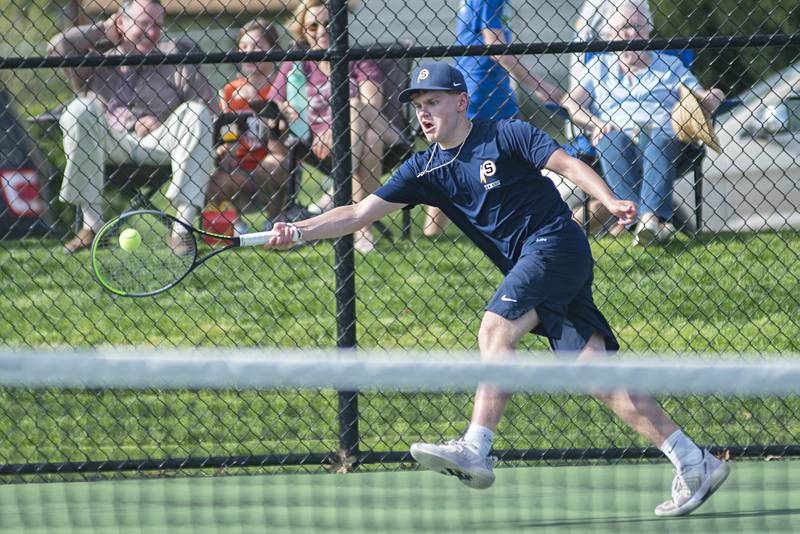 Sterling’s Kayden Loos stretches for a shot against Newman’s Griffin Moran and James Rhodes Monday, May 9, 2022. Loos was playing with doubles partner Ben Boze.