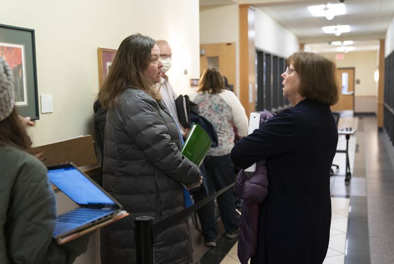 Two candidates for Algonquin-based Community School District 300 – school board Kristina Konstanty, left, and Laurie Parman – chat in line Monday, Dec. 12, 2022, the first day local candidates could file for the April election, at the McHenry County Administration Building in Woodstock.