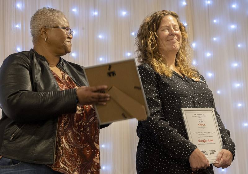 Jennifer Lang (right) smiles after being named the winner of the Louise Bittorf Sullivan award Thursday, April 18, 2024 at the YWCA Women of Achievement Luncheon.  Award winners are those who exhibit inspiration, energy, vision, charm and accomplishment.