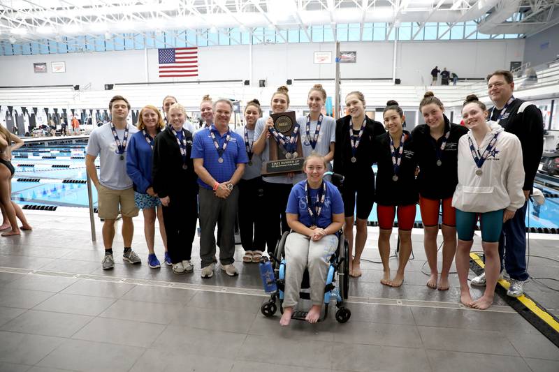 St. Charles North swimmers celebrate their second place combined trophy in the IHSA Girls State Swimming and Diving Championships at the FMC Natatorium in Westmont on Saturday, Nov. 11, 2023.