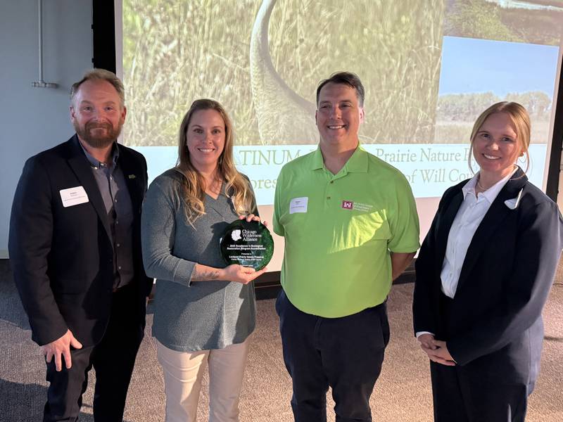 Pictured from left are Forest Preserve District of Will County Deputy Director Adam Oestmann; Forest Preserve District restoration ecologist Barbara Sherwood; Jason Zylka, ecologist with the U.S. Army Corps of Engineers, Chicago District; and Laurie Ryan, co-chair for the Excellence in Ecological Restoration Program and plant ecologist for McHenry County Conservation District.