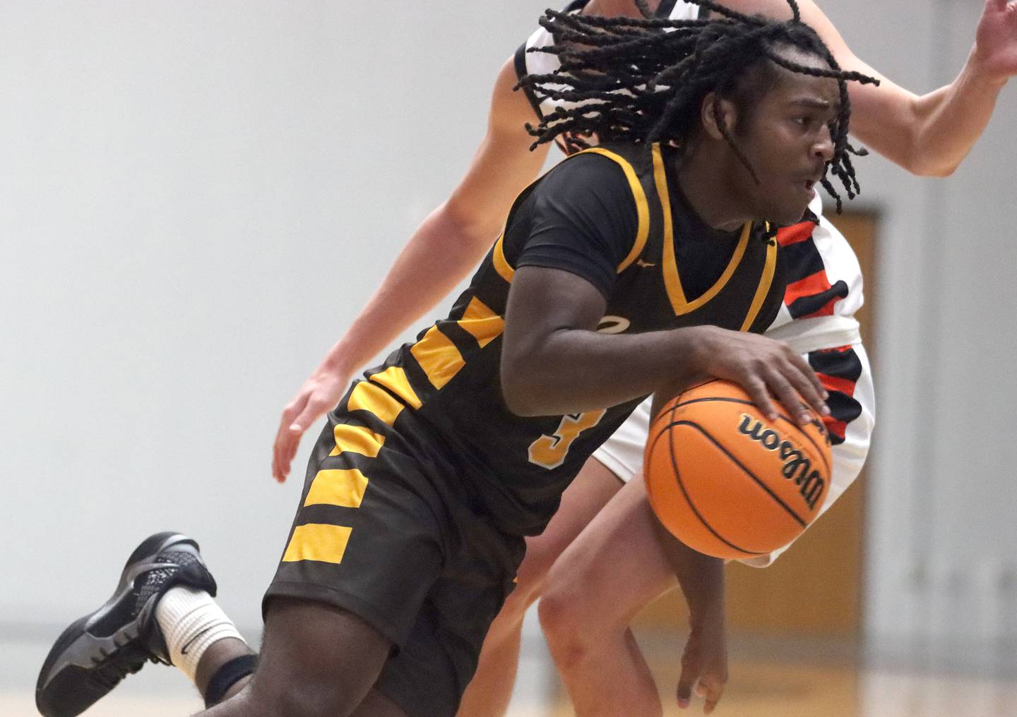 Jacobs’ Emaan Thomas drives with the ball in varsity basketball on Wednesday, Dec. 4, 2024 at McHenry High School in McHenry.