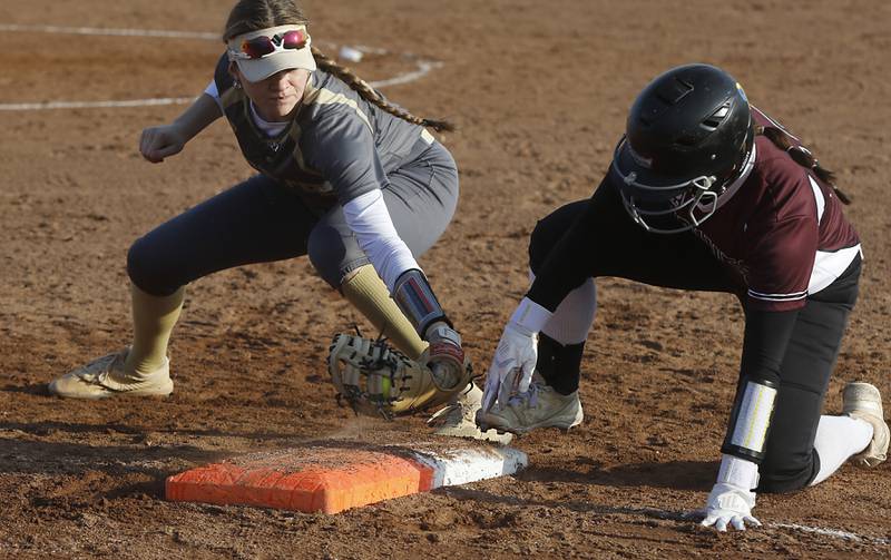 Grayslake North’s Morgan Nielsen tries to tag out Prairie Ridge’s Emily Harlow as she tries to get back to first base during a nonconference softball game Thursday. March 23, 2023, at Grayslake North High School.