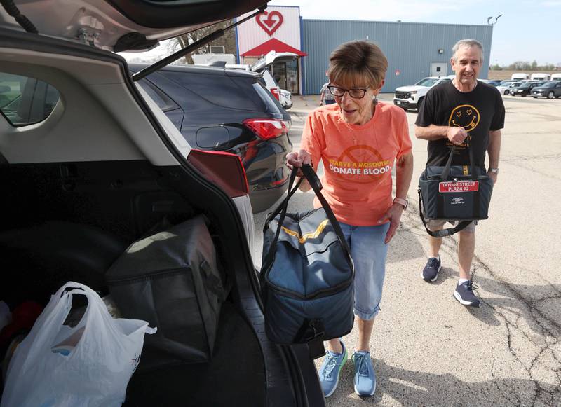 Volunteers Julie and John Ahlbach load up their van Friday, April 17, 2026, to deliver food to local residents as part of the Voluntary Action Center’s Meals on Wheels program.