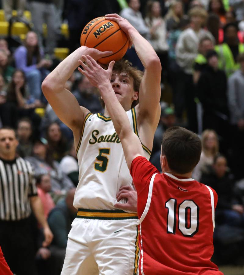 Crystal Lake South's Carson Trivellini shoot the ball over Huntley's Brady Hassels during a Fox Valley Conference boys basketball game on Friday, Jan. 30, 2026, at Crystal Lake South High School.