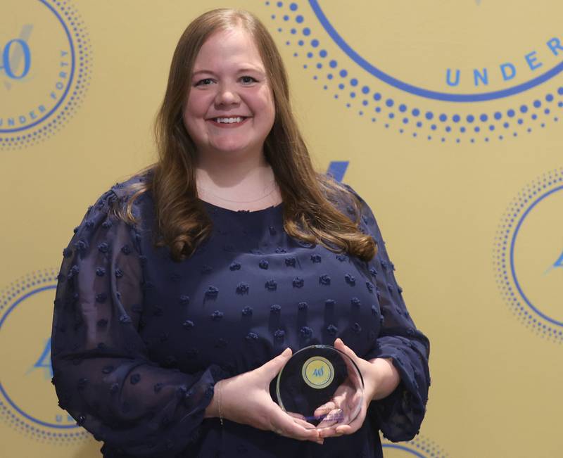 Bailey Wallace poses with her 40 Under Forty award during the Illinois Valley Chamber of Commerce Champions of Change Awards Night on Wednesday, May 6, 2026 at the Westclox Event Center in Peru.