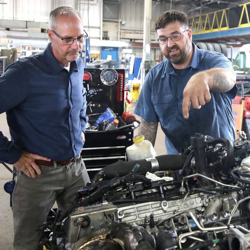 Jon Bockman, (left) owner of Bockman’s Auto, Truck & Tire, talks to lead technician Adam Zonka Friday, Aug. 2, 2024, about a repair they are working on at the DeKalb location on Industrial Drive.