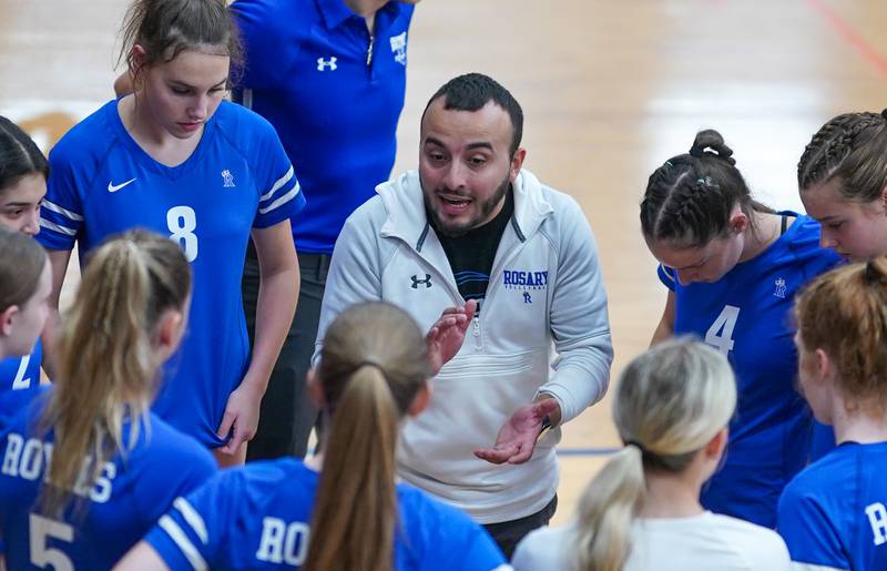 Rosary’s head coach Francisco Martinez talks to his players before the start of a volleyball match against Oswego at Oswego High School on Tuesday, Aug 29, 2023.