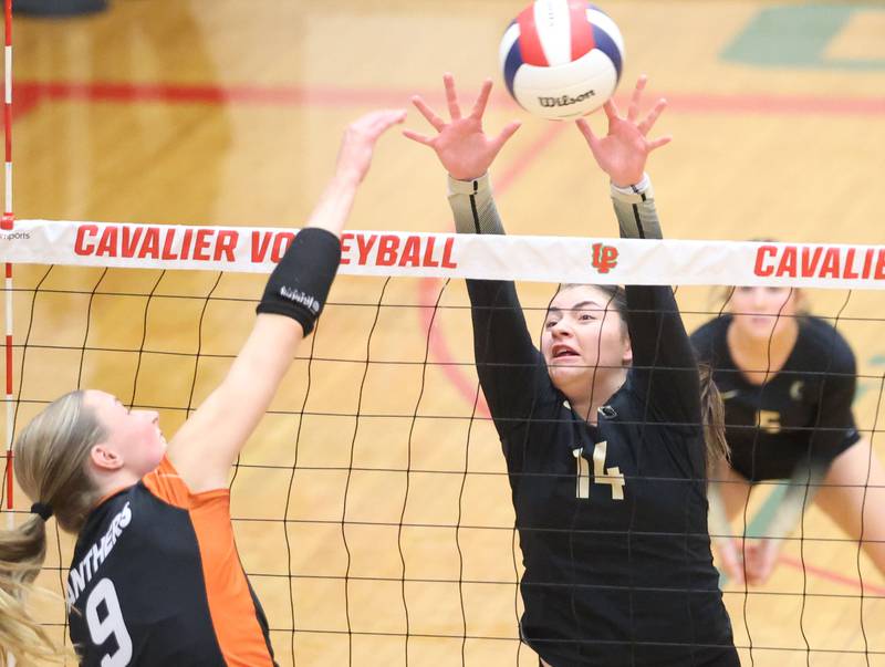 Sycamore's Norah Chami blocks a spike from Washington's Carly Dawson during the Class 3A Sectional semifinal game on Tuesday, Nov. 4, 2025 in Sellett Gymnasium at L-P High School.